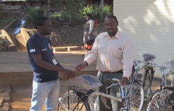 Adyasi Bamusi (left) receives advice on bicycle care from Lilongwe District Environmental Health Officer Mavuto Thomas.