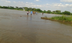 The KenyaEMR team wades across the Turkwel River.