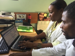 Dr. Regine Juste (left)  works on iSanté with Dr. Marinho Elisma, I-TECH Haiti's Lead Clinical Mentor.