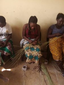 A young woman learning to weave a basket during the September 9-13, 2019 craft-skills training session. 